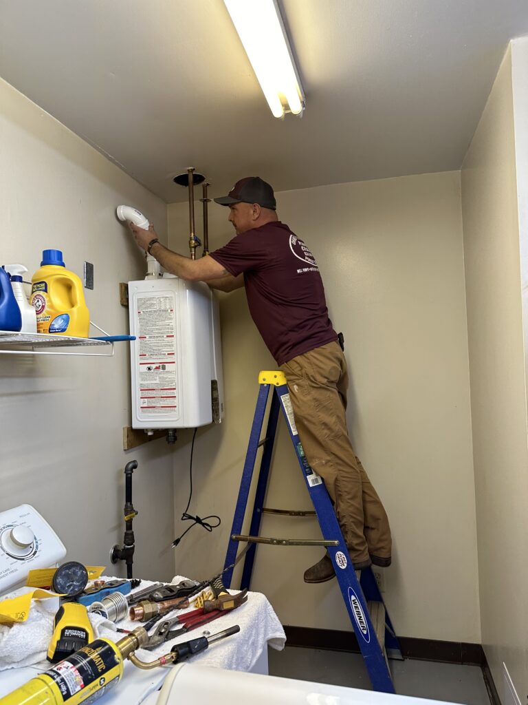 NC Water Heater Plumber working on a tanless water heater