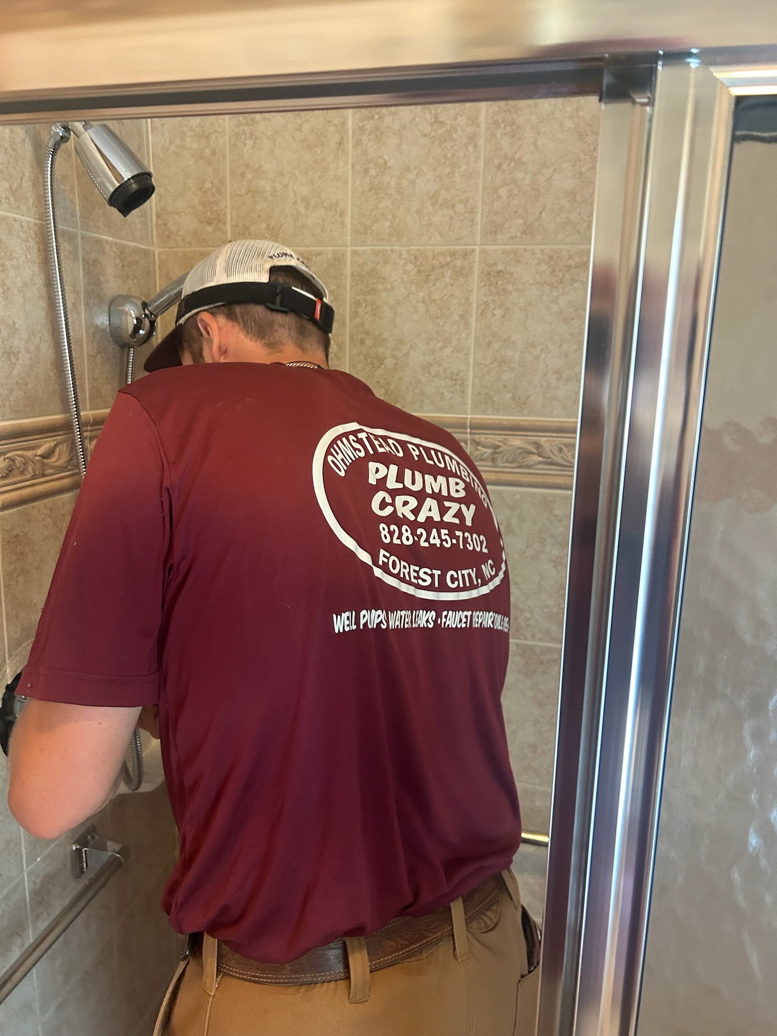 local NC plumber working on shower head replacement